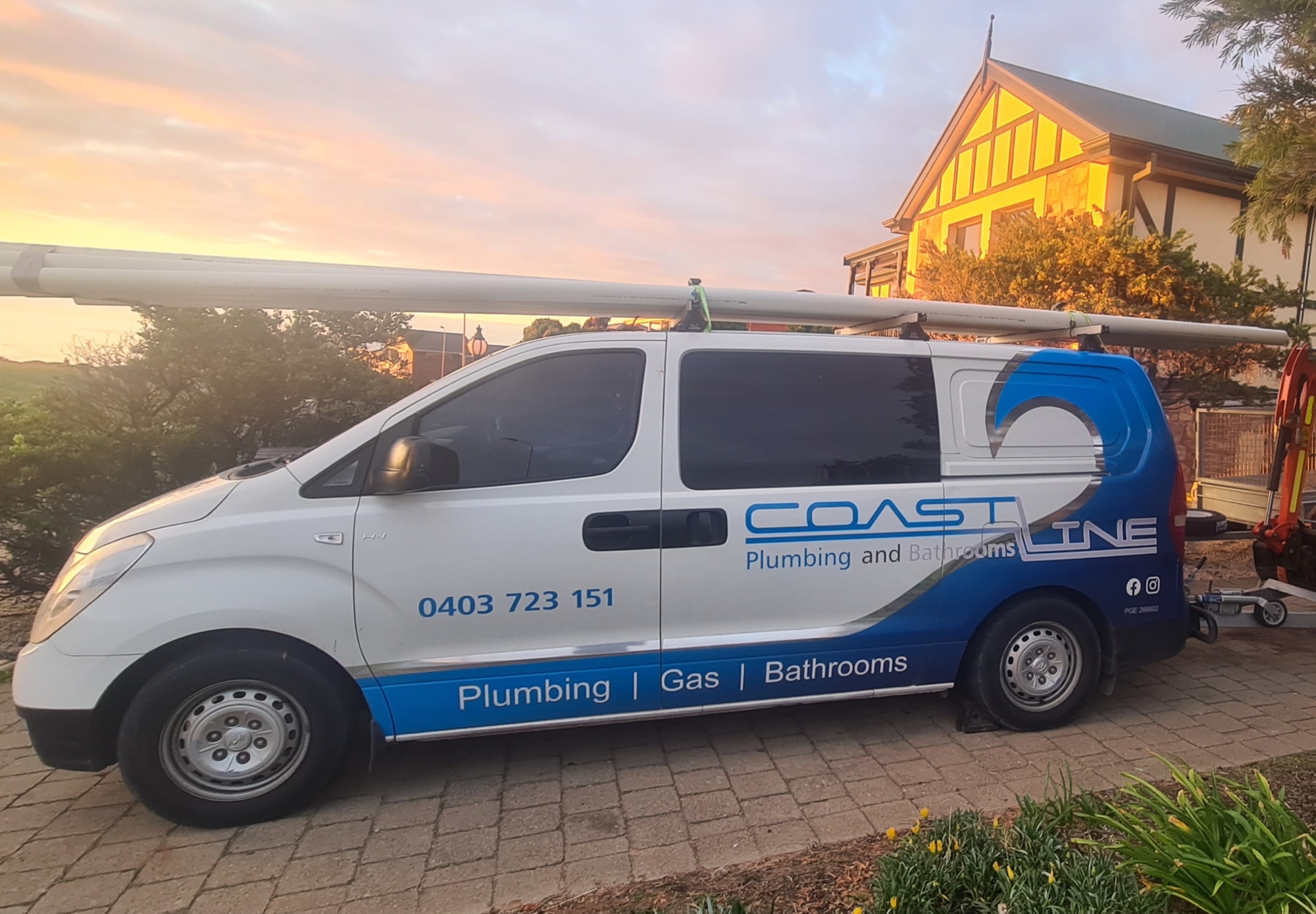 Coastline Built plumbing and bathroom renovation service van carrying pipework